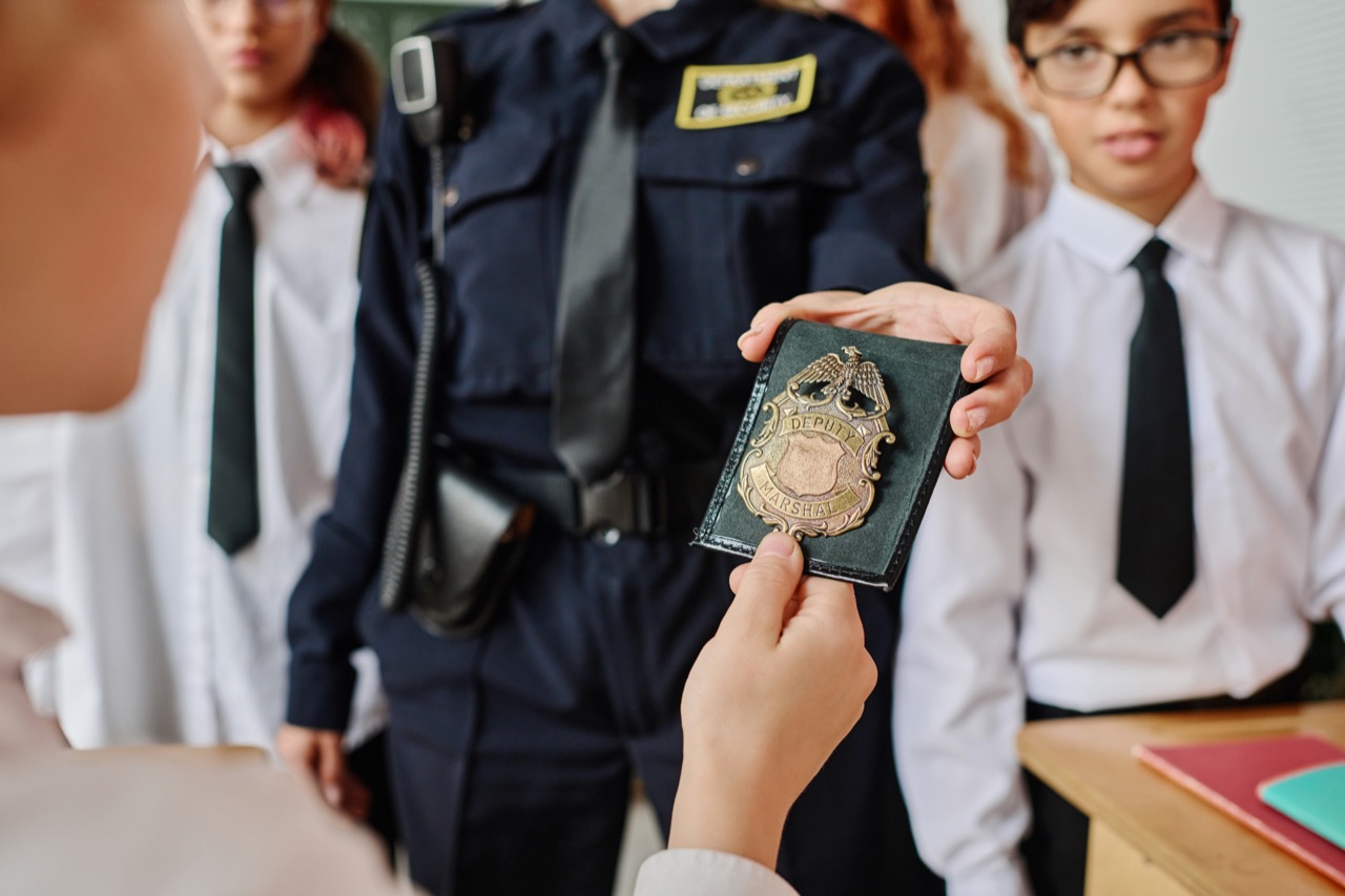 unrecognizable-office-showing-police-badge-to-kids-2025-02-11-17-12-54-utc.jpg