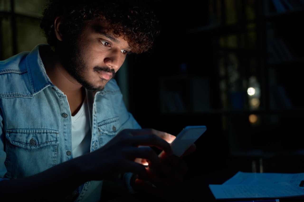 young-indian-man-using-mobile-apps-on-cell-phone-l-2025-02-11-16-17-45-utc.jpg