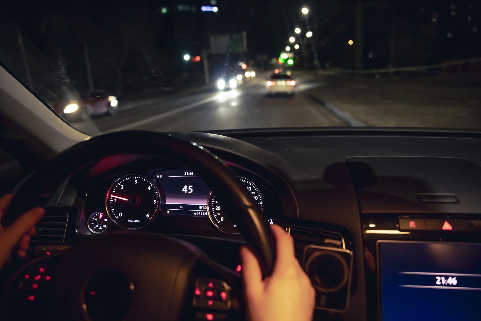 Driver's view of a car on a city street at night